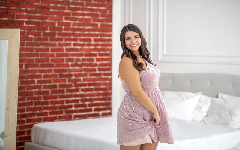 woman wearing cure lacey outfit smiling and posing