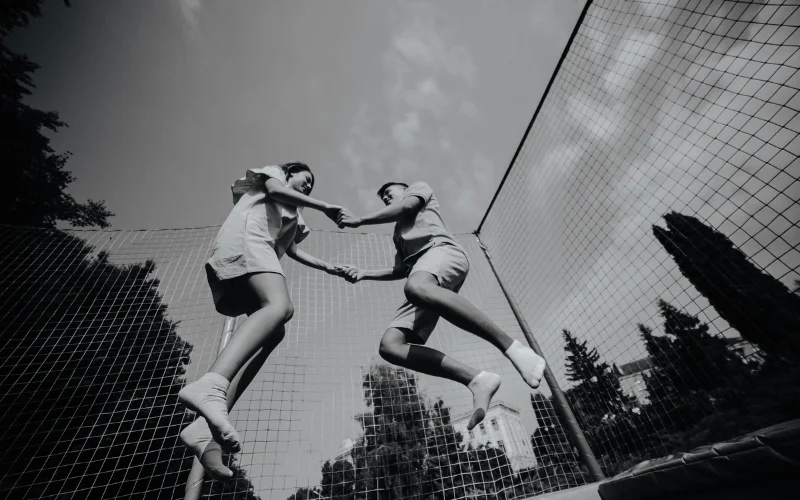 candid photo poses
 - couple jumping on a trampoline candid picture poses