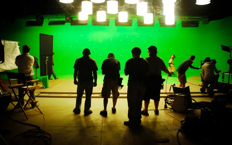 crew working on set with green background