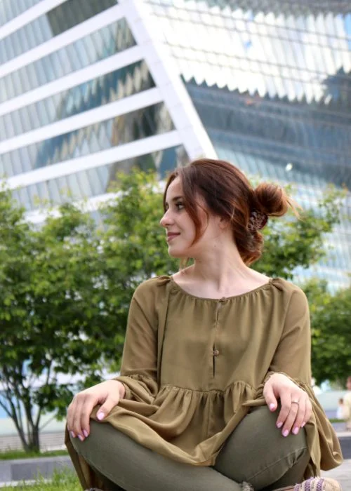 Artistic sitting pose with creative angles and modern portrait photography style