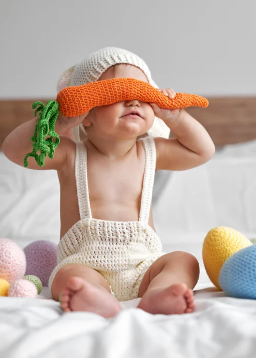 baby holding carrots, Easter baby photography, Easter-themed newborn photos, Easter newborn props