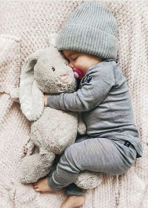 baby snuggling a stuffed bunny, newborn Easter outfit photos, spring newborn photography, Easter baby portrait ideas.