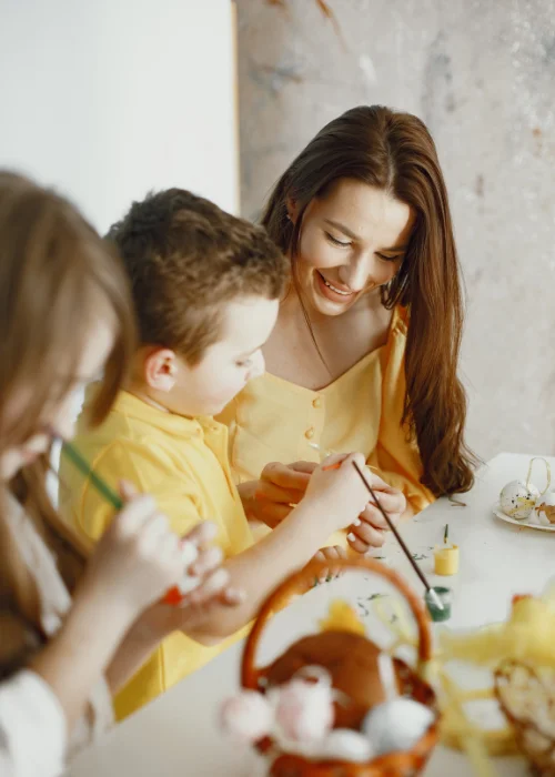 photo of family painting eggs, Easter family photography, Easter family picture ideas, Easter-themed family photos