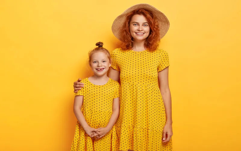 studio photoshoot of mom and daughter in Matching clothes