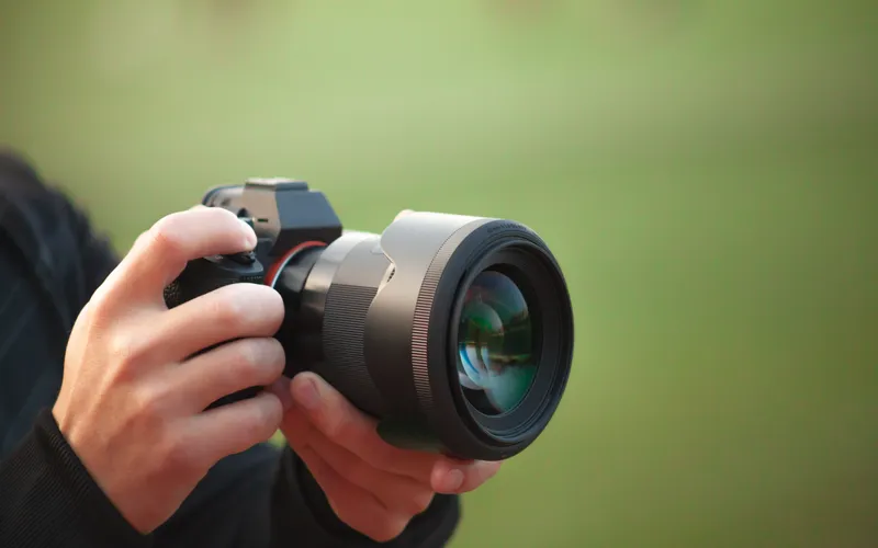 photographer holding DSLR camera