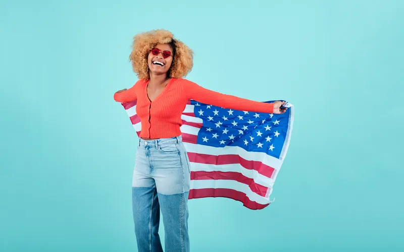 girl holding flag on 4th July