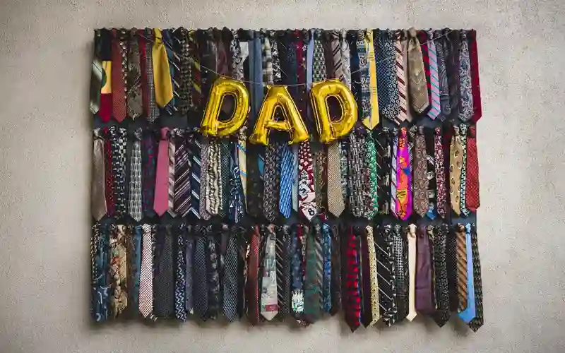 Festive necktie display with gold dad balloons