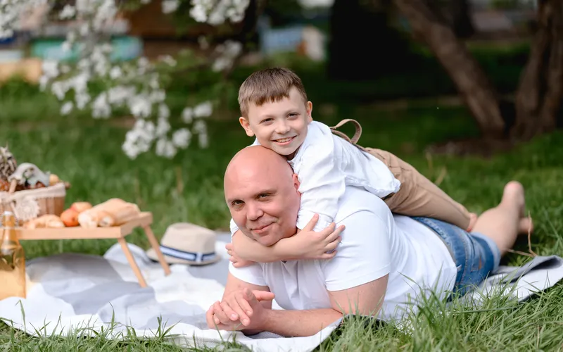 father and son enjoying outing in garden