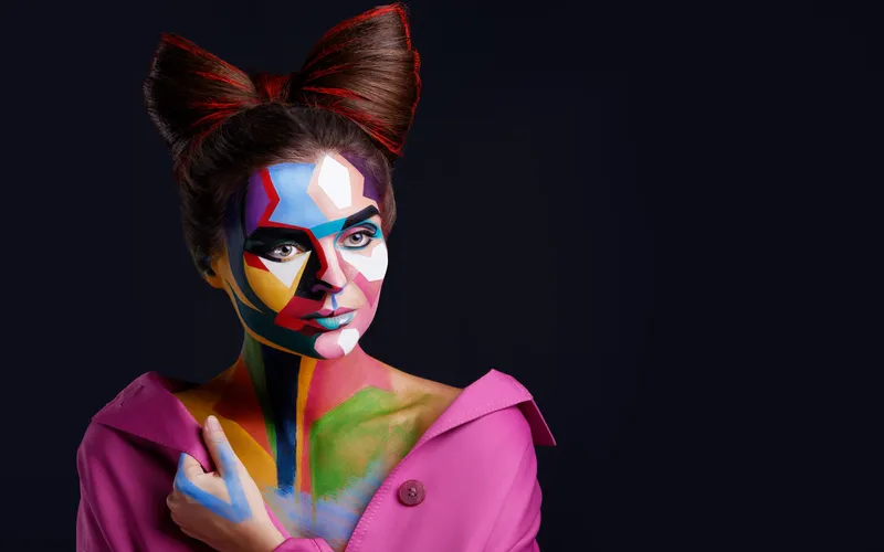 Fine art portrait of a woman with colorful geometric face art and makeup