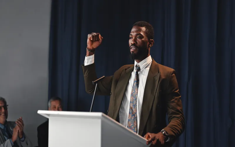 photo of man giving speech in natural lighting