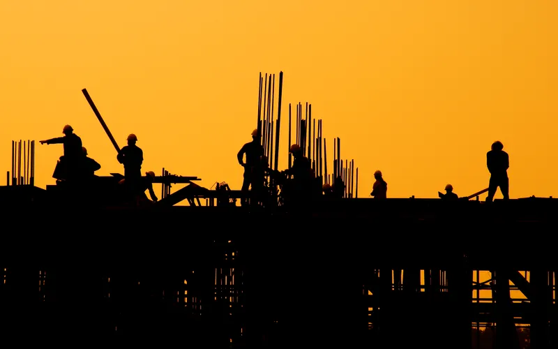 photo of Silhouette of Labor working on a construction site