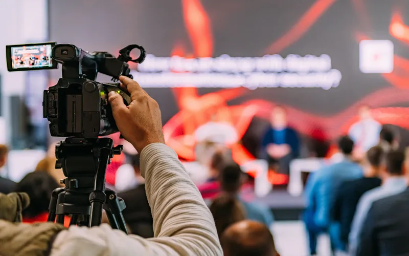 cameraman filming business presentation