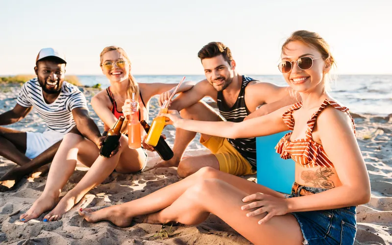 friends enjoying beach picnic/party