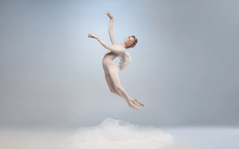 model in angel's attire levitating in the air
