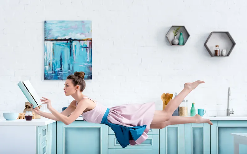 levitation photography of woman reading books