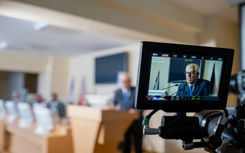 man giving presentation on a camera screen display