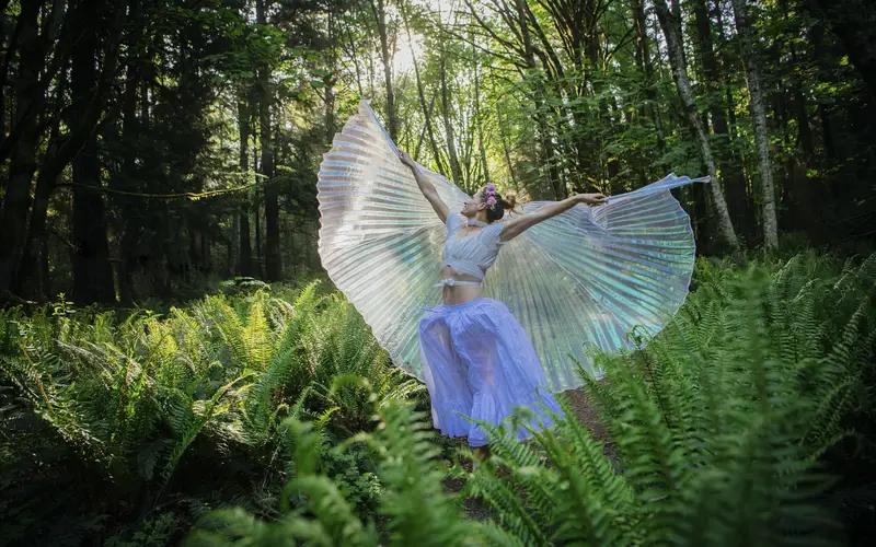 a woman posing with angel wings