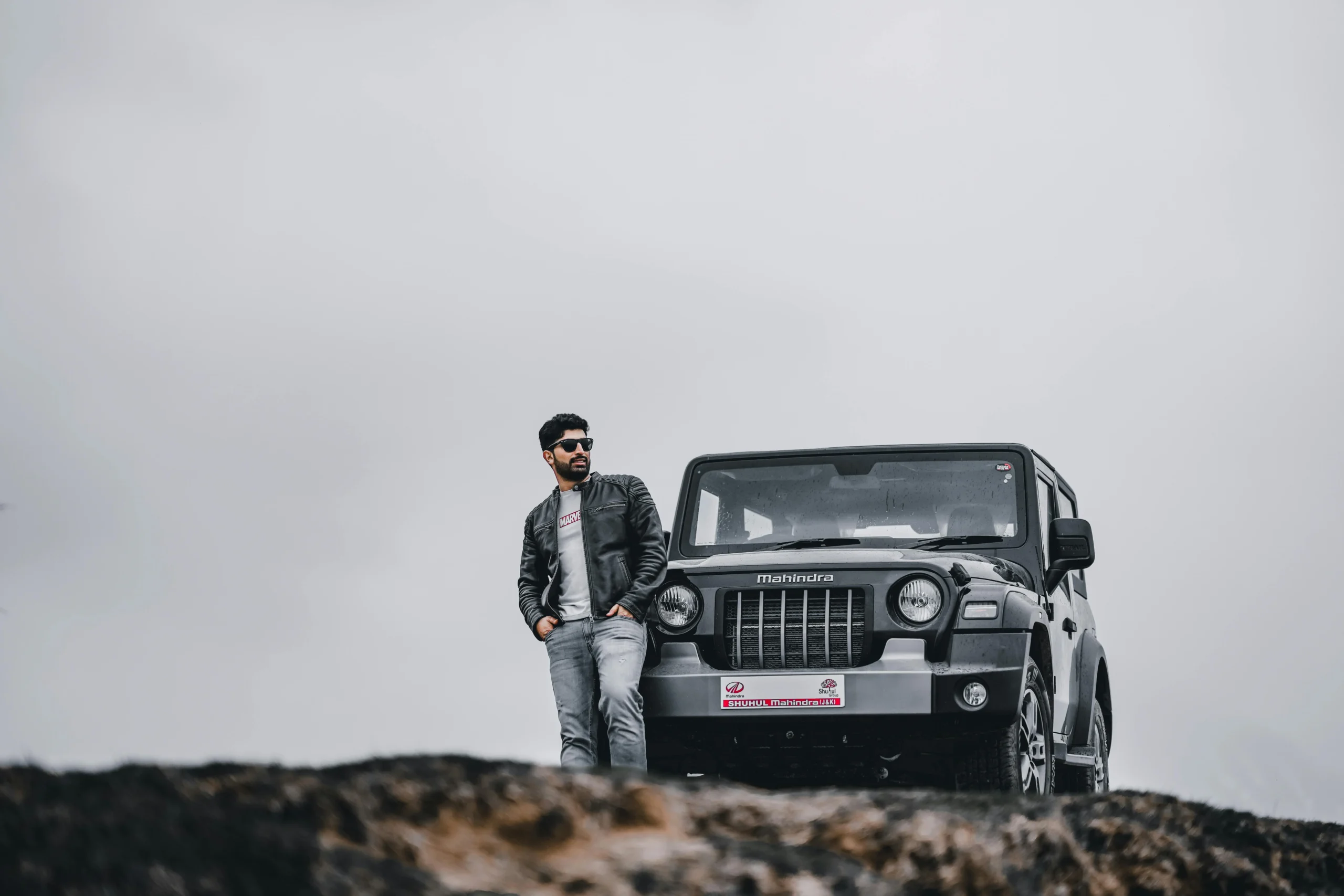 car photo pose - a wide shot of a man with his car