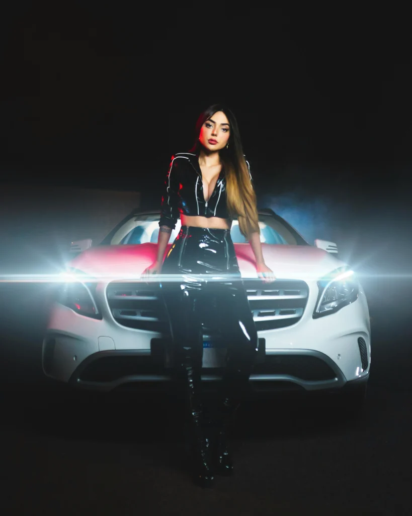 photoshoot with car ideas - a model posing in front of the car