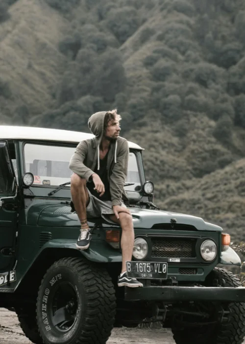 a man sitting on a jeep