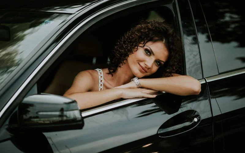 vintage car photoshoot ideas - a model posing on the window of a car
