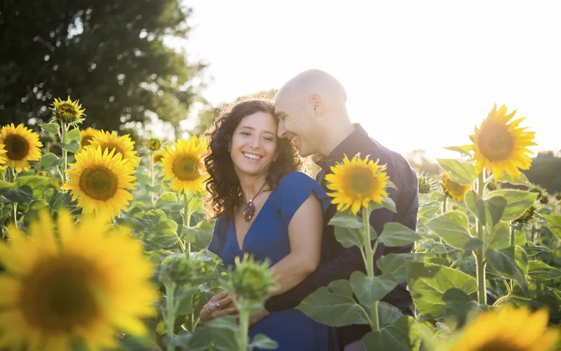 candid portrait of a couple in the sunflower field