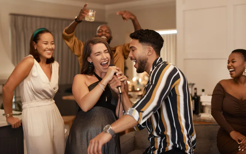 friends having fun dancing and singing