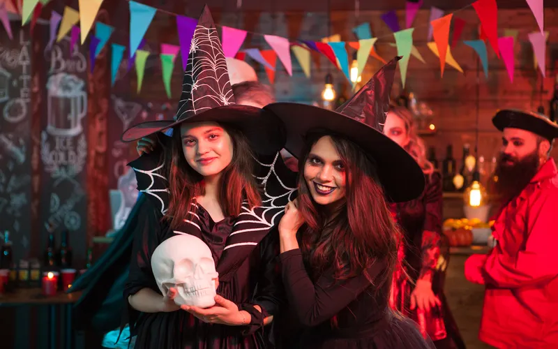 young adults celebrating Halloween in scary carnival decoration