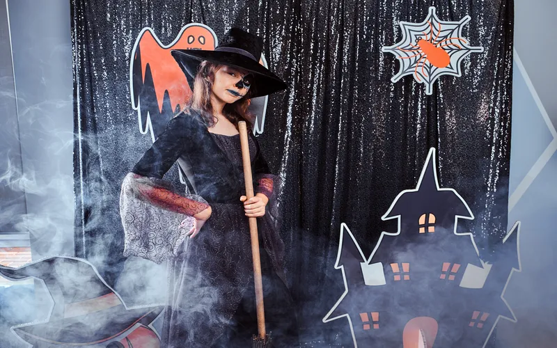 Instagram worthy Halloween Photo Booth Backdrop- and a woman in costume posing in front of it