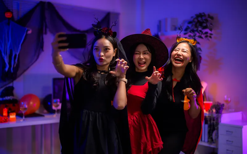 Creative Halloween Photo Booth- three women in Halloween costumes taking selfies