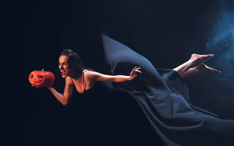 levitating women posing as a witch for Halloween photoshoot