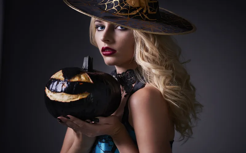women in armour holding a pumpkin head for photoshoot