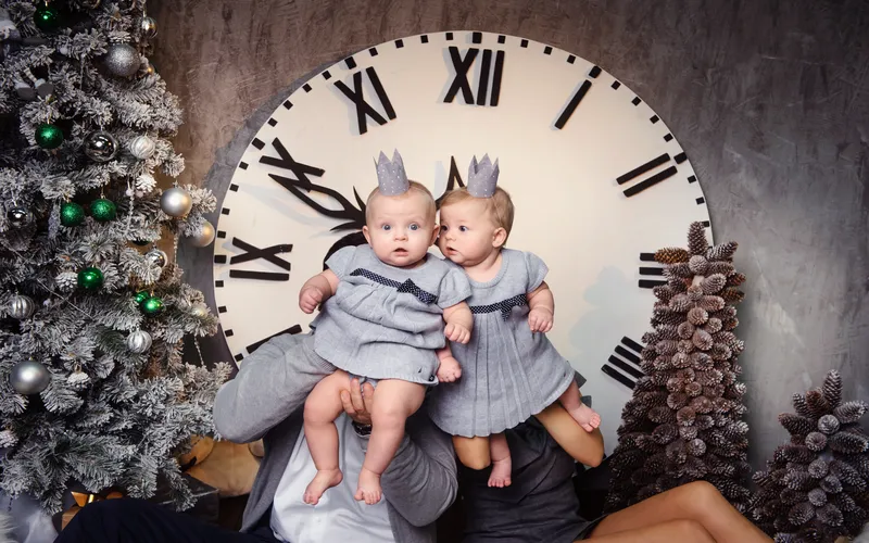 adorable twin babies near giant clock