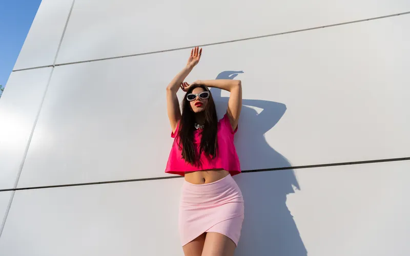 womens standing with her arms in the air - posing for glam photoshoot