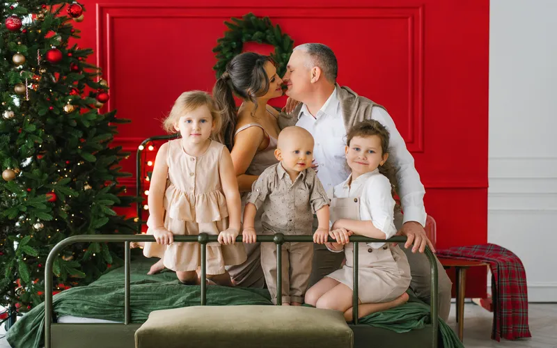 Family celebrating Christmas and posing for a photo