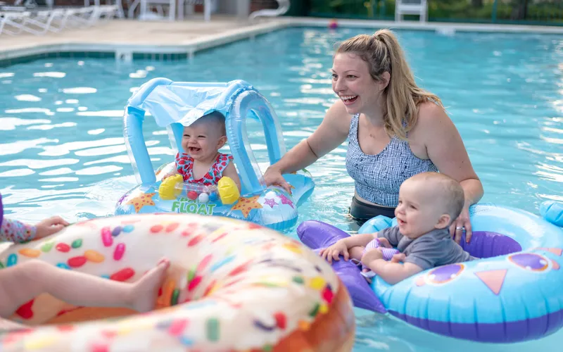 two kids and their mother enjoying in the pool