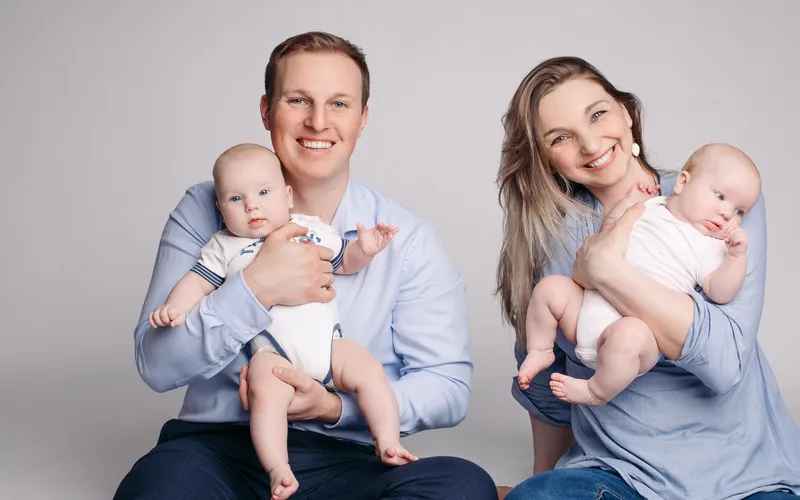 couple posing with newborn twins