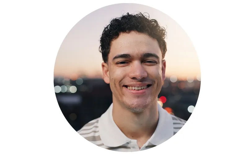 portrait of a man against city lights in background at evening