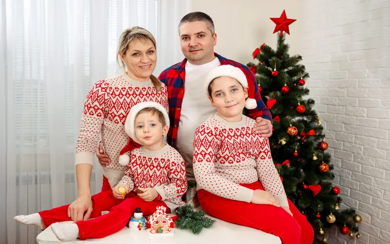 family posing for a photo in matching sweaters