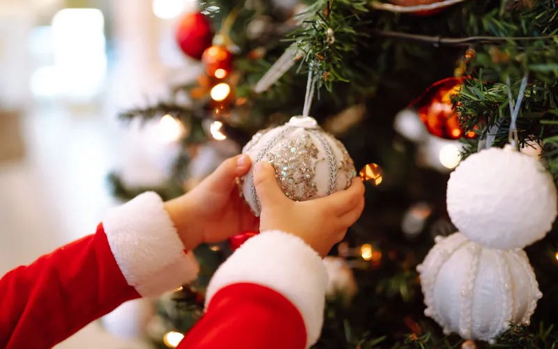 decorating Christmas tree with ornaments