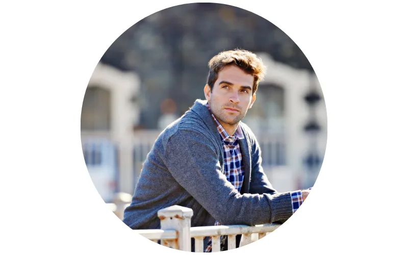 portrait of a man leaning on the fence whith curious expression on his face