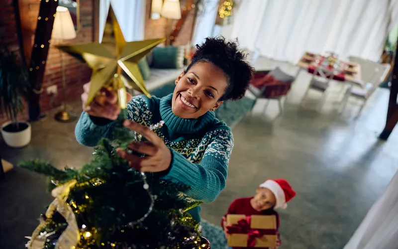 Woman and child decorating Christmas tree