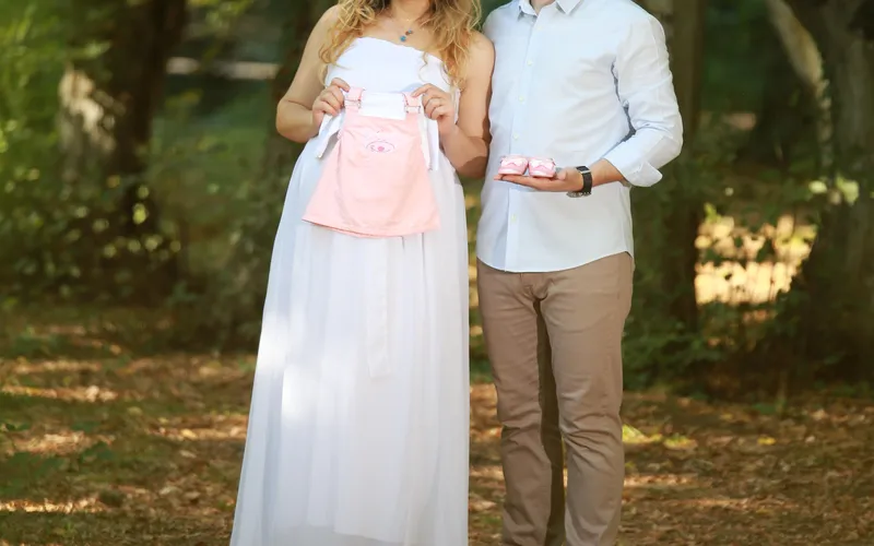 expecting couple revealing the gender of their baby with Baby clothes