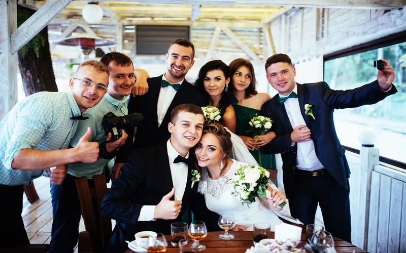 groomsmen photobombing the bride and the grooms photo
