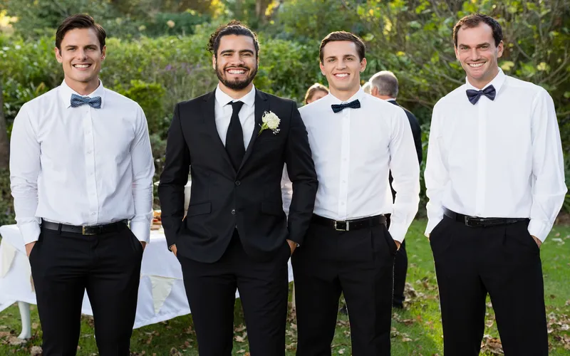 groomsmen posing for a photo in straight line