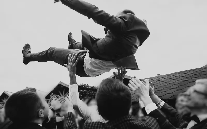groomsmen carrying the groom