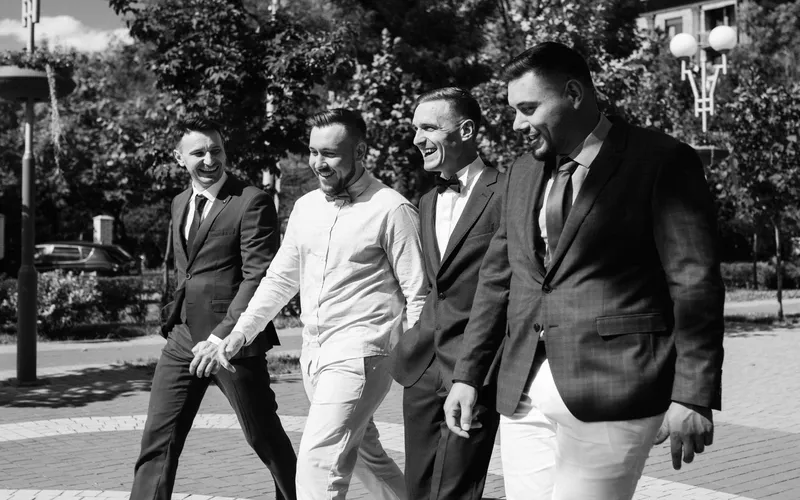 groomsmen and the groom walking together