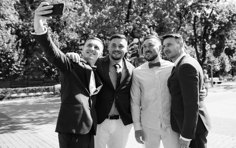 groomsmen taking a selfie together