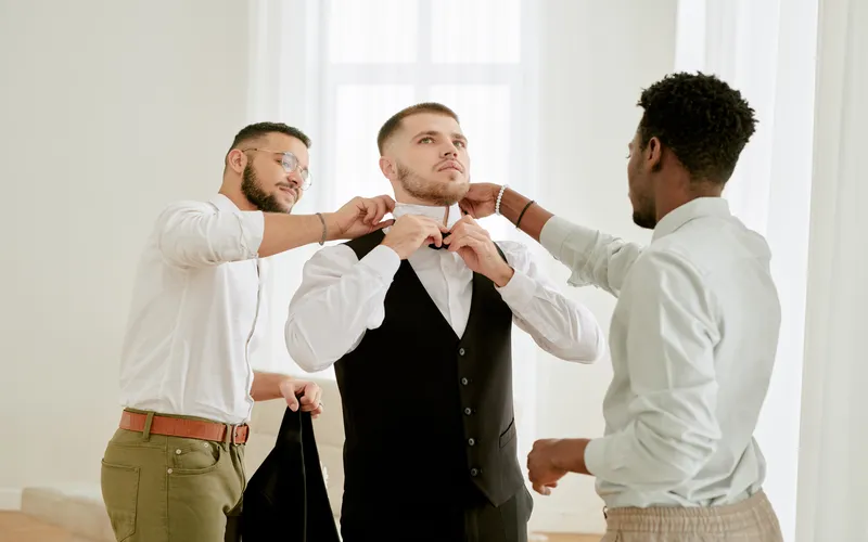 groomsmen helping the groom get ready