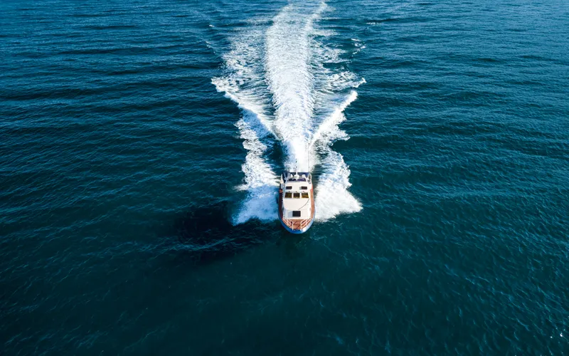drone shot of a speed boat sailing in the sea